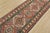 A tribal Caucasian Kazak runner hand-knotted with fine wool on a cotton foundation. This rug features a row of geometric...