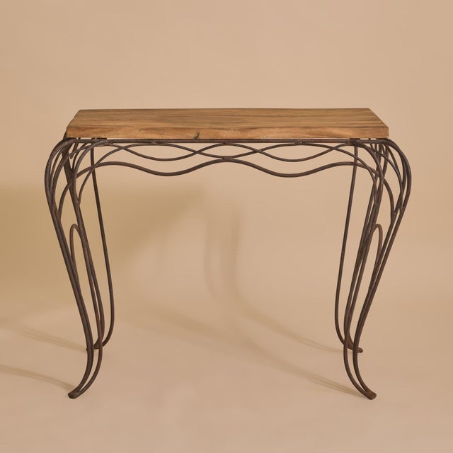 A French wrought iron console table in the manner of André Dubreuil from the latter part of the 20th Century. The rich,...