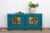 Dive into coastal charm with this captivating high-gloss turquoise blue painted cabinet. Clean lines and aged wood...