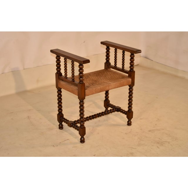 19th century oak bench with arms from England. This bench is such a great piece! The arms on the bench give it some nice...