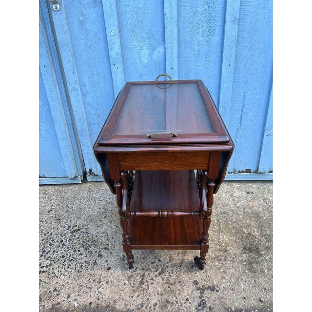 Antique Victorian Style Mahogany Drop-Leaf Tea Bar Cart With Removable Tray. The two tiered cart with larger back wheels...