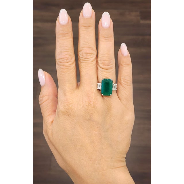 This exquisite ring features a captivating GIA-certified natural 10.43-carat emerald-cut emerald, radiating a rich green...