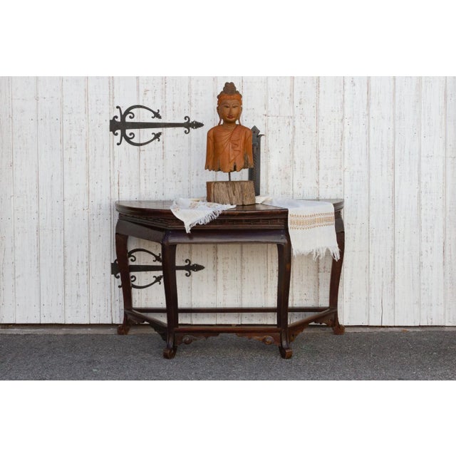 A stylish antique Chinese Demilune console table. This lacquered brown elm table features a half moon top with ornately...