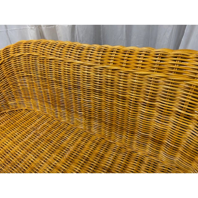 Monumental vintage rattan wicker sofa in the style of Michael Taylor to float in your space. Seat height is 13" without...
