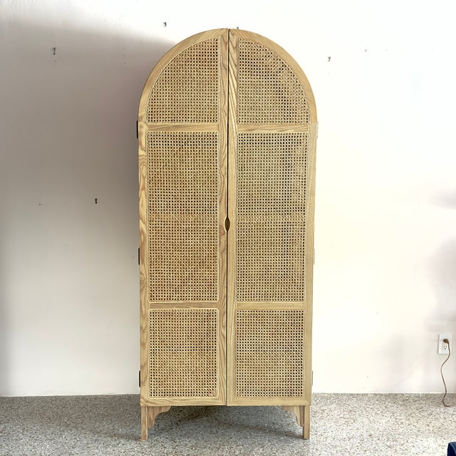 Elevate your home storage with our stunning arched rattan armoire. Expertly crafted from premium solid wood and accented...