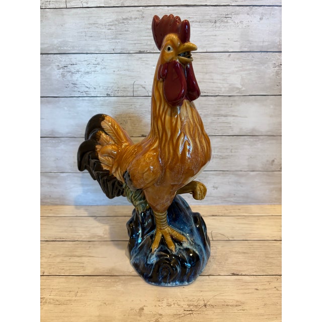 A richly colored vintage ceramic rooster with expressive modeling and a lustrous glazed finish, capturing the decorative...