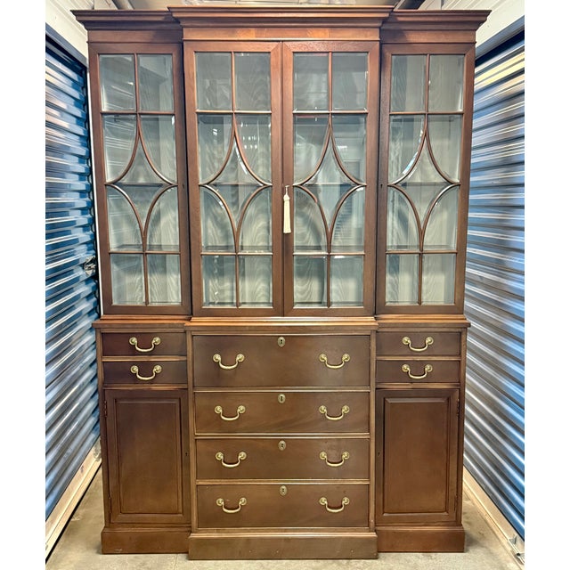 Beautiful Federal-style Henredon breakfront china cabinet. Upper interior is brightened by a cream-colored lining....