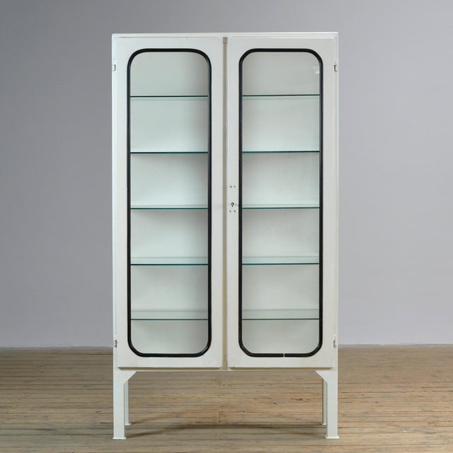 Vintage medical cabinet from the 1970s, made in Hungary. This characterful cabinet is made of iron and glass, with the...