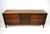 A mid-century walnut low boy dresser with nine drawers perfect for your storage needs with the three center drawers having...