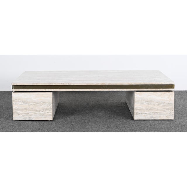 A monumental and stunning Travertine coffee table or cocktail table in the manner of Karl Springer. This table would look...