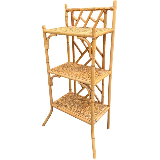 Beautiful vintage bamboo and rattan étagère featuring three wood shelves with woven rattan and split bamboo detailing,...