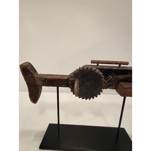 One of a kind wonderful folk art sculpture of a machine gun in rustic wood with some of its original painted finish. The...