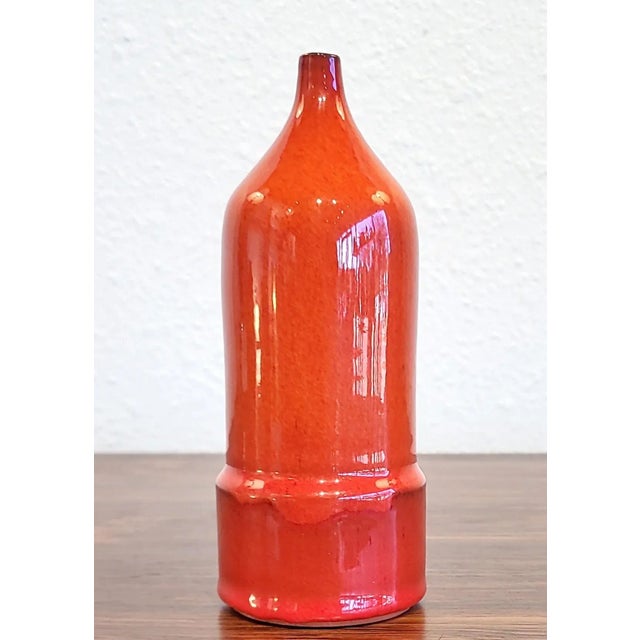 A rare, bottle-form bud vase with a narrow, tapered neck and a selenium-red glaze by Rogier Vandeweghe for AMPHORA of...