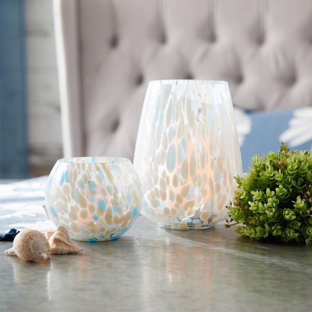 Add a fresh, coastal touch to your decor with the Painted Glass Candle Holder Vase Set. Featuring cool blue and white...
