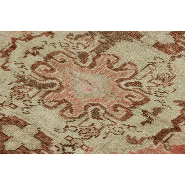 Made with hand-knotted wool, this 1x3 gift-sized vintage Turkish rug originating circa 1950-1960, is from the collection...