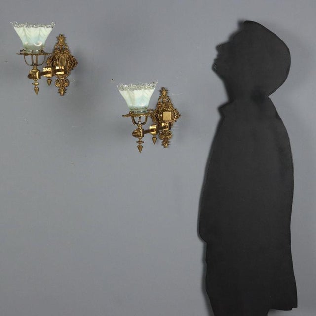 Pair of period brass wall lamps, 1 light. Wall plaque featuring decorative leaf motifs, swing arm, glass light holder....