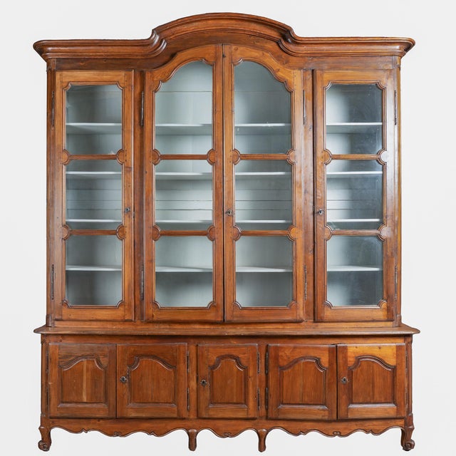 Impressive late 18th-century French pine bookcase showing a deep aged patina and traditional provincial design. At over...