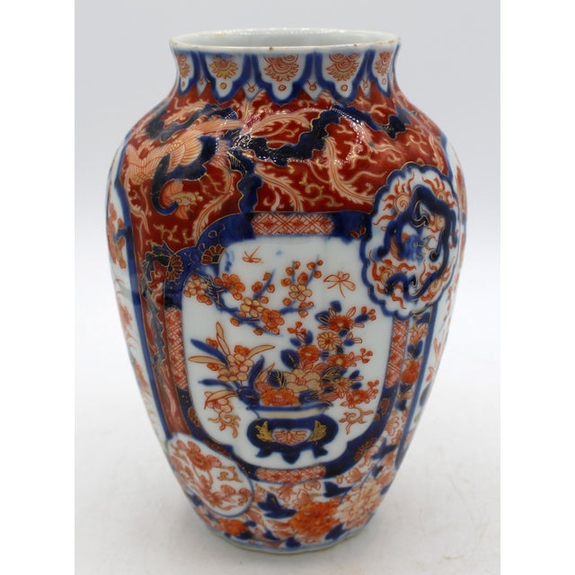 Circa 1860-80 Japanese Meiji period Imari vase. Ribbed body elegantly decorated with reserves of a jardiniere overflowing...