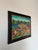 Charming M. Bazile Haitian folk art painting depicting a lively outdoor market scene filled with vibrant colors, figures,...