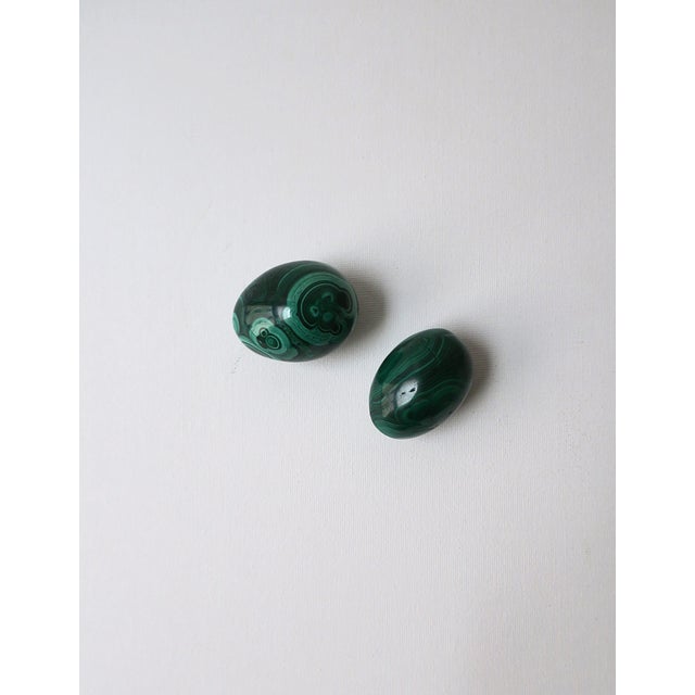 A beautiful set of two (2) green Malachite eggs decorative objects, circa 20th century. Malachite egg objects are hand-...