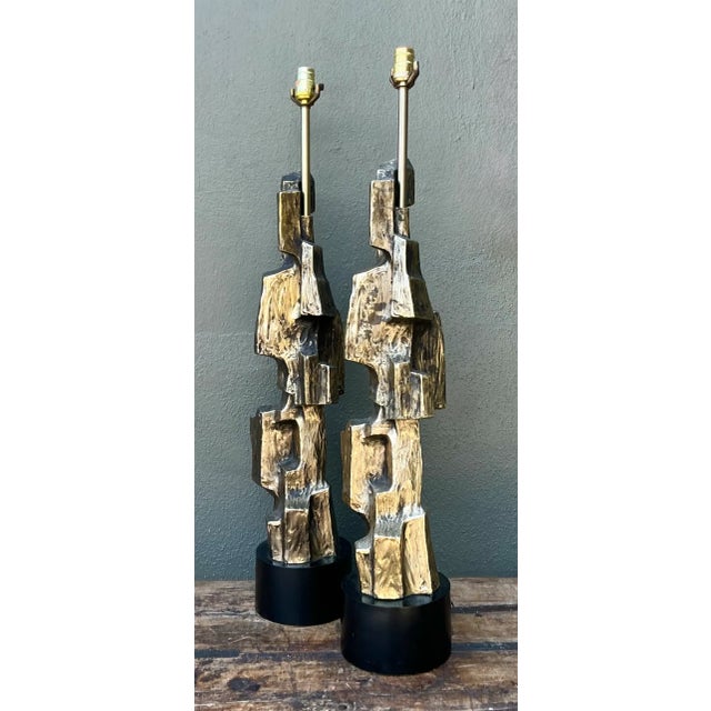 Captured in raw, architectural forms, this pair of mid-century Brutalist table lamps designed by Richard Barr for Laurel...