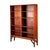 A vintage stand-alone bookcase crafted in teak with adjustable shelves, lifted off the floor by solid teak legs. An...