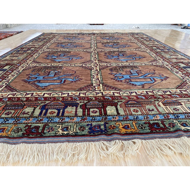 This vintage rug was hand-knotted in wool by artisan weavers working in the Afghan Ersari tribal tradition. Measuring 8'4"...