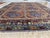 This vintage rug was hand-knotted in wool by artisan weavers working in the Afghan Ersari tribal tradition. Measuring 8'4"...