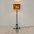 Elegant French floor lamp dating from the 1940s, crafted from wrought iron with a beautifully aged dark green and bronze...