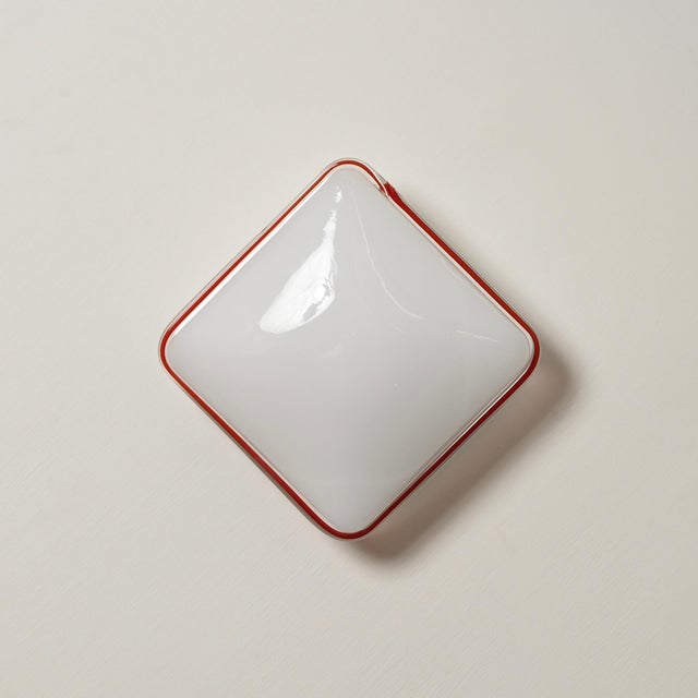 Wonderful pair of mid-century flush-mount ceiling or wall lights in white murano blown glass with an elegant red glass...