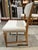 This refined side chair features ivory hide, warm teak tapered legs and distinctive double rows of bronze nail heads for a...
