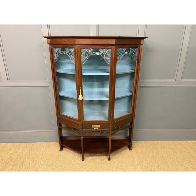 A charming Arts and Crafts period mahogany display cabinet in the manner of Charles Rennie Mackintosh. Well constructed in...