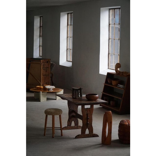 This Swedish expressive mid-20th-century table is a beautifully handcrafted piece made in solid pine, showcasing an...