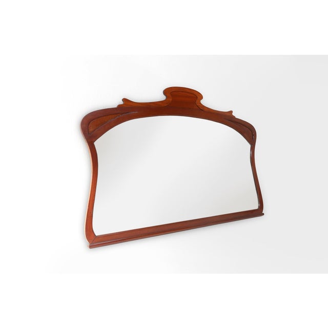 Unique Art Nouveau chimney mirror in oak, made in France around 1910. The oak frame is hand-carved and has the flowing,...