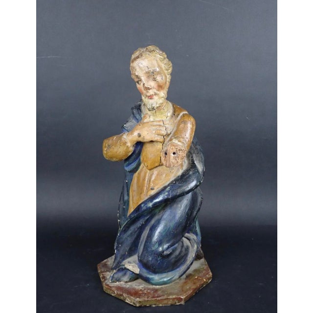 This antique Continental, (Possibly French) European polychrome carved wood figure represents a kneeling biblical figure...