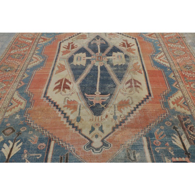 Hand-knotted in wool, this 9x13 antique Bakshaish tribal carpet from Persia dates to circa 1890–1900. A collectible piece...