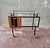 Splendid bar/food trolley dating back to 1950. Black painted iron frame and two glass shelves. Good condition.