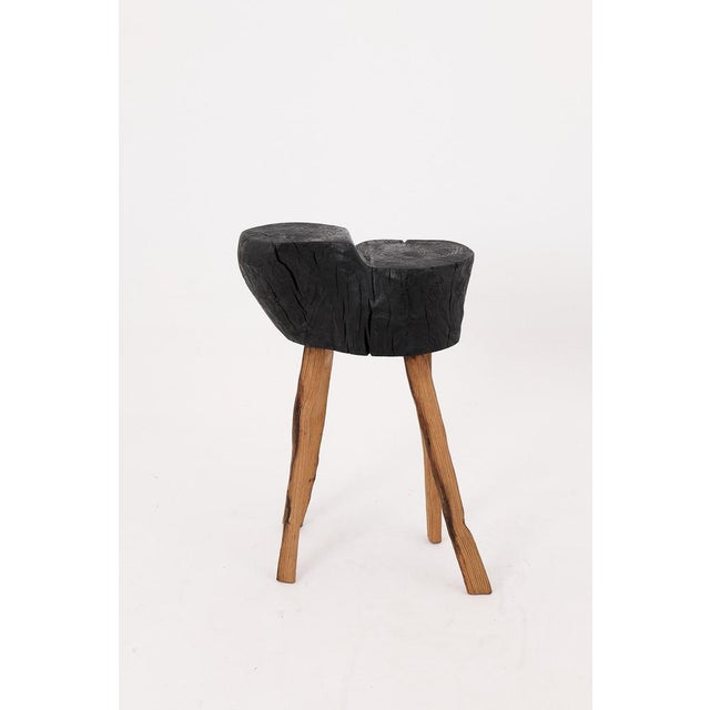 This sculptural side table is a one-of-a-kind work of functional art, carved by hand from a single hardwood log and...