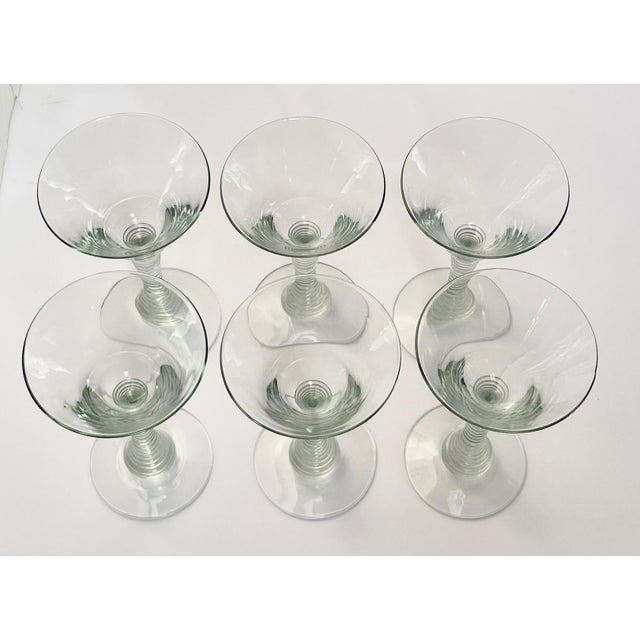 These beautiful crystal glasses have ribbed stems, pontil marks on the bases, and occasional bubbles from the hand-blowing...