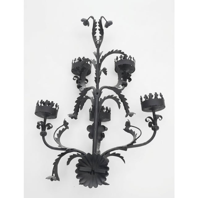 With its commanding silhouette and rich, dark patina, this mid-century Spanish Baroque-style wrought iron 5-light candle...
