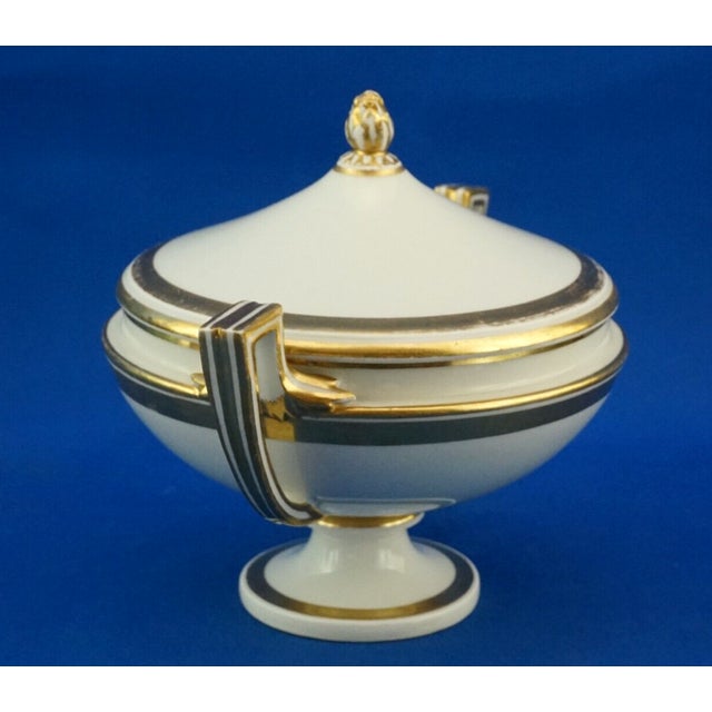 A magnificent candy jar, featuring a lid with a pine cone-shaped knob, a small potiche in the finest, creamy white...