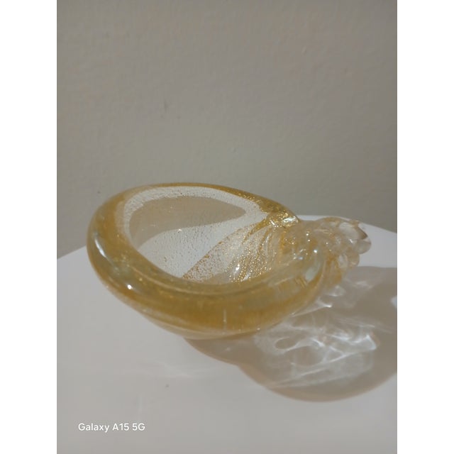 Styled after Italian Murano glass. Shell with real gold flakes. Smooth texture. Not signed. It's in excellent condition.