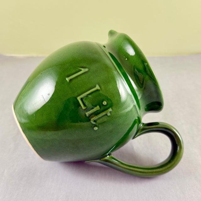 A vintage green glazed pottery pitcher, made in Italy and marketed by Williams-Sonoma, discontinued in 2007. The deep...