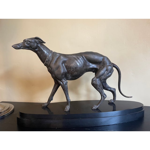 Art Deco 1920s statue of a greyhound on a black polished slate base. The dog is beautifully stylized. Material: zamak and...