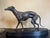 Art Deco 1920s statue of a greyhound on a black polished slate base. The dog is beautifully stylized. Material: zamak and...