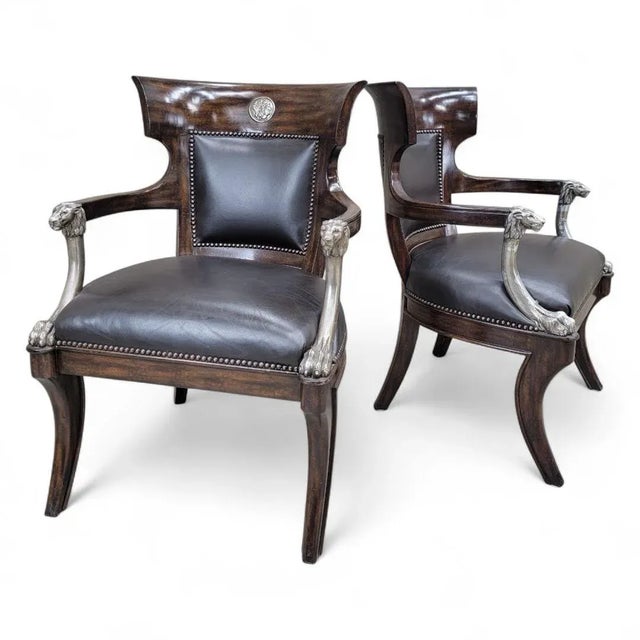 Vintage George IV English Regency Style Black Leather Chairs with Metal Lion Head Arms and Saber Legs - Pair This...