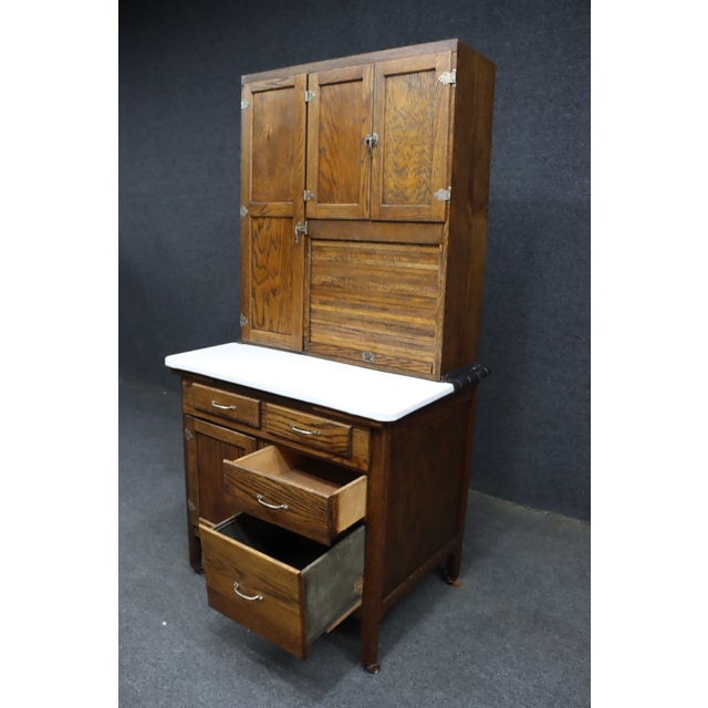Rare and unusually compact 36-inch-wide oak Hoosier cabinet, featuring a warm golden oak finish and original-style metal...