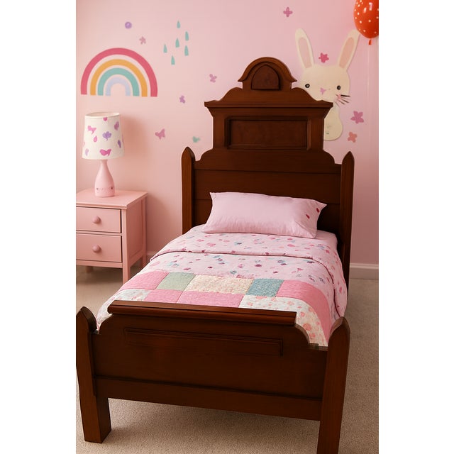 A rare and beautifully preserved Victorian Monumental Walnut Youth Bed, showcasing the ornate craftsmanship and...