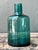 This vintage teal glass vase is a refined example of mid-20th-century design, celebrated for its clean lines and striking...