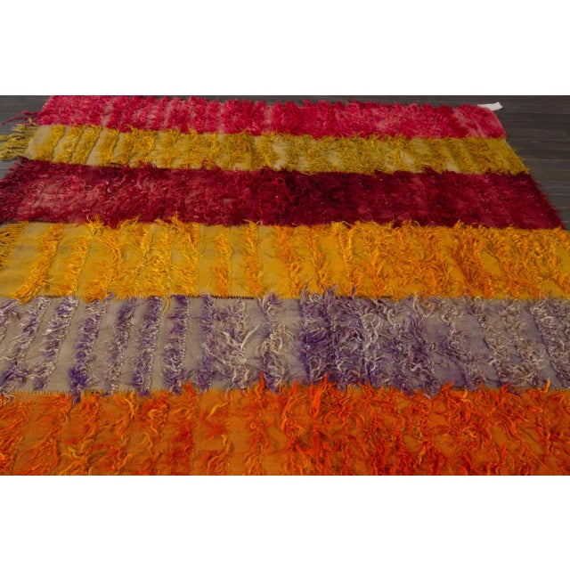 This beautiful hand-knotted geometric designed wool rug with multicolor accents. This rug measures 6'1" x 6'11".